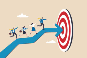 Illustration of business professionals walking along a large blue arrow toward a red target, symbolizing teamwork, strategy, and goal achievement.
